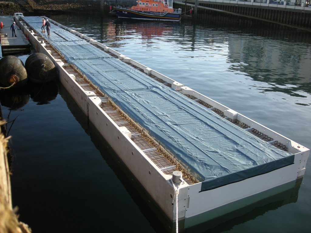 The MCMV pontoons being hinged together before the concrete is pumped to stitch the deck